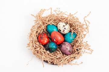Multi-colored quail eggs for Easter in the filler