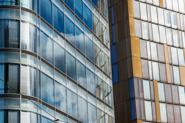 Modern Office Buildings with Glass Windows and Sky Reflections on a sunny day