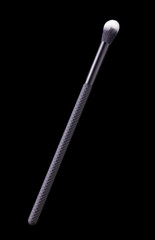 Cosmetic makeup eyeshadow brush isolated on a black background