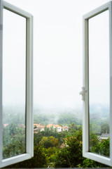 Open a window to air the room. Ventilate your house. Window with amazing countryside view on foggy...