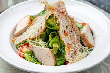 Salad caesar with chicken on white plate