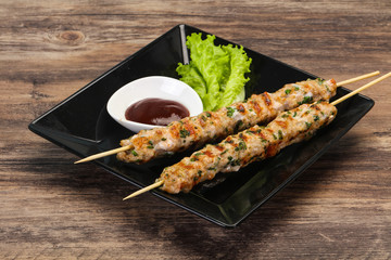 Minced pork skewer kebab with sauce