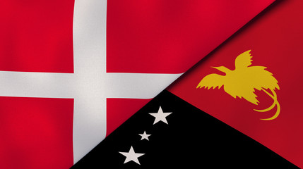 The flags of Denmark and Papua New Guinea. News, reportage, business background. 3d illustration