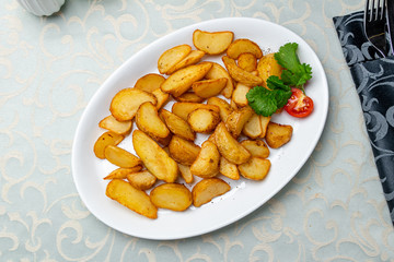 Fried potatoes wedges on plate