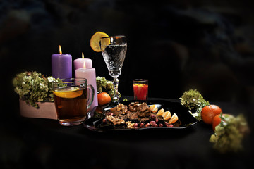 Delicious food. Beautiful glass with lemon. Festive dinner. big candles. tangerines