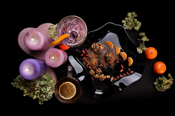 Delicious food. Beautiful glass with lemon. Festive dinner. big candles. tangerines