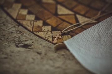 A small Orthodox Christian cross on a string for the sacrament of baptism.