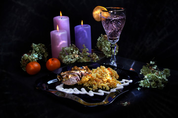 Fototapeta na wymiar Delicious food. Beautiful glass with lemon. Festive dinner. big candles. tangerines