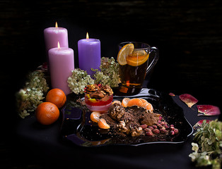 Delicious food. Beautiful glass with lemon. Festive dinner. big candles. tangerines