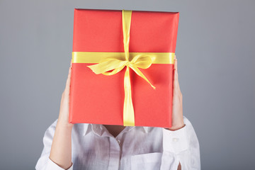 woman hand gift box in face