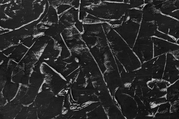 Black wall with abstract pattern and white color. Reminds black crumpled paper