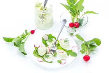 boiled stuffed eggs with green cheese filling with arugula leaves and radish