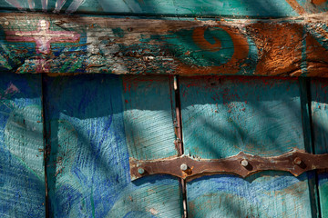 Colorful blue green wood fence with metal bracket