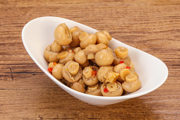 Pickled champignons in the bowl