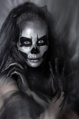 close up portrait of girl with professional Halloween skull makeup. Black veil