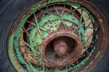 An old spoke wheel hub rusting and losing paint