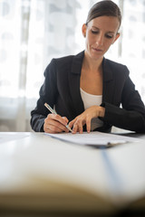 Businesswoman signing a document