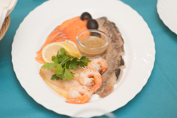 salmon, shrims, meat with lemon and parsley