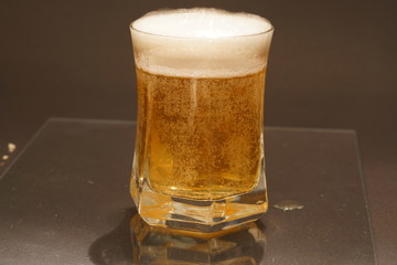 glass of beer on dark background