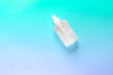 COVID-19 SARS-COV-2 Pandemic  personal protective equipment - hand sanitizer. Text STAY SAFE.  Blue background. Copy space.