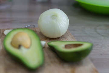 Peeled onions and halves of avocado