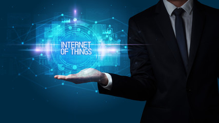 Obraz premium Man hand holding INTERNET OF THINGS inscription, technology concept