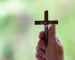 hand holding a wooden cross, easter