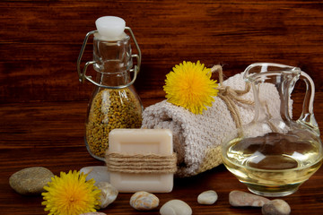 dandelion pollen and oil next to soap and towel