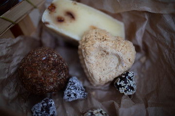 Handmade cheese with spices in the shape of hearts and balls.