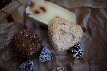 Handmade cheese with spices in the shape of hearts and balls.
