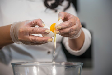 hands preparing eggs for cooking