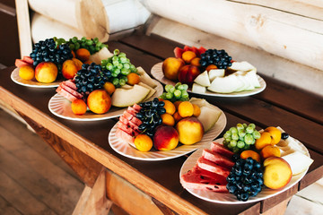 Plates with fruits on a wooden table
