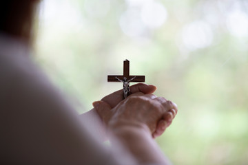 hand holding a wooden cross, easter