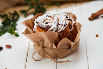Easter cake decorated by raisins and icing sugar on white wooden background, Traditional Kulich, Paska  ready for celebration