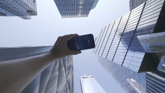 POV on Tourist Photographing Skyscrapers in Financial District in NYC in 4K Slow motion 60fps
