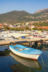 Fototapeta na wymiar Fishing boats in harbor, beautiful Mediterranean landscape. Montenegro, Adriatic Sea, Bay of Kotor. View of Marina Kalimanj in Tivat city