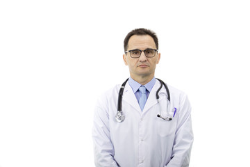 The therapist with glasses in a white coat with a stethoscope stands on a white background and looks at the camera. Medical worker. Serious look. Portrait of a doctor. Copyspace