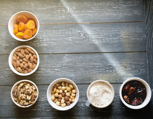 ingredients to make protein energy balls, dates, apricots, nuts, collagen powder. healthy snack to take witn you. less sugar concept. low carb diet and vegan food. top view