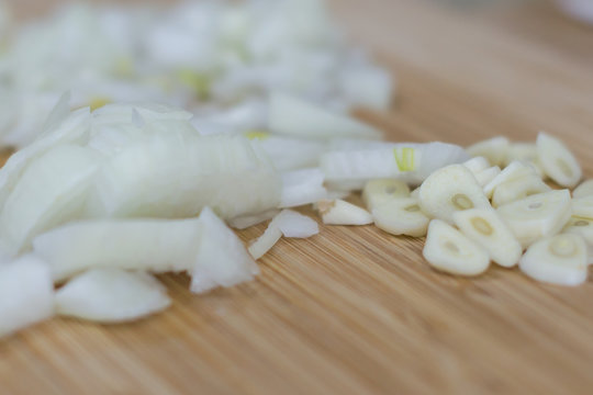 Cutted garlic and onios on a wooden background
