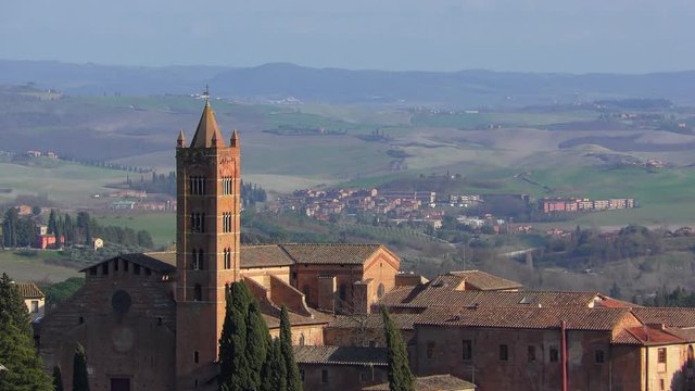 The view from the heights of the rooftops of medieval Siena and the beautiful hills in the surrounding area. Tuscany, Italy.