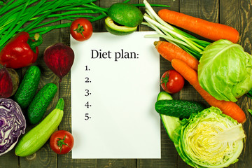 making a diet plan, diet and nutrition plan, a set of fresh vegetables, the concept of healthy food and a beautiful figure, place for text