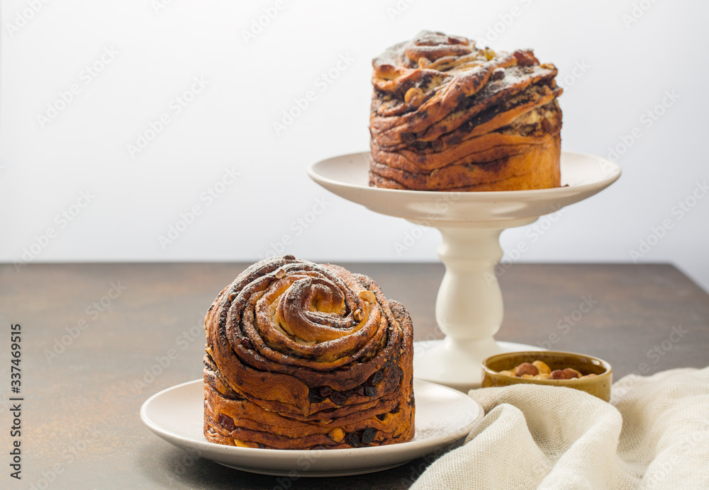 Sticker homemade cruffin cake, made with yeast. filled with butter, chiocolate, nuts and raisins. minimalist