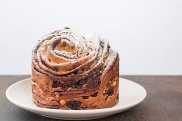 Homemade cruffin cake, made with yeast. Filled with butter, chiocolate, nuts and raisins. Minimalistic. 
