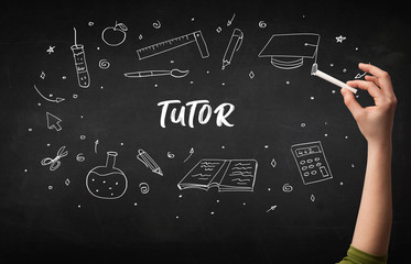 Hand drawing TUTOR inscription with white chalk on blackboard, education concept