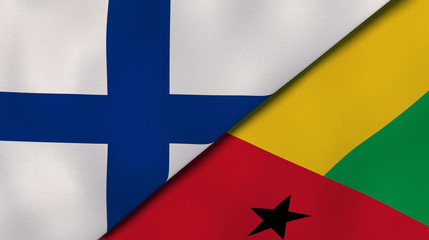 The flags of Finland and Guinea Bissau. News, reportage, business background. 3d illustration