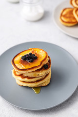 Pancakes. Stack of pancakes with honey on a gray background. Homemade breakfast