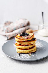 Pancakes. Stack of pancakes with honey on a gray background. Homemade breakfast