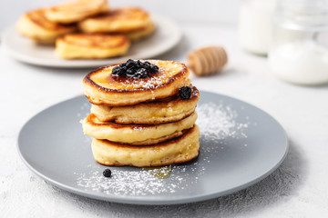 Pancakes. Stack of pancakes with honey on a gray background. Homemade breakfast