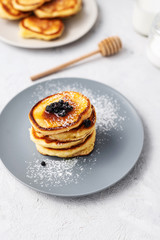 Pancakes. Stack of pancakes with honey on a gray background. Homemade breakfast