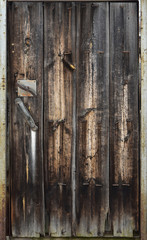Old wooden door. Vintage texture of the plank surface of the door leaf